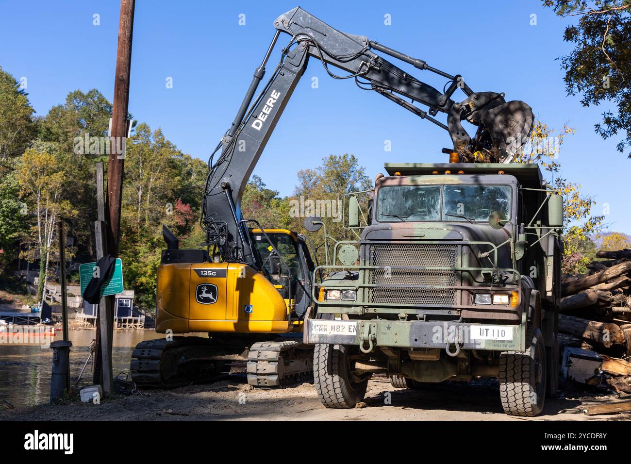 A contractor uses heavy equipment to remove debris from Lake Lure ...