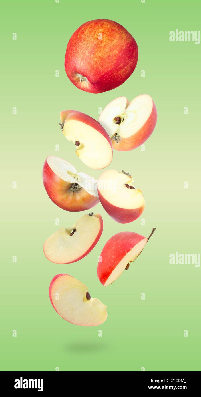 Fresh red apples in air on green background Stock Photo - Alamy