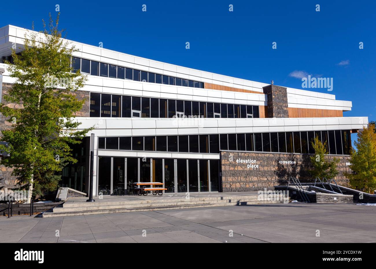 Elevation Place Canmore Recreation Centre Building Exterior Facade Front View.  Modern Architecture Facility Alberta Canadian Rockies Autumn Skyline Stock Photo