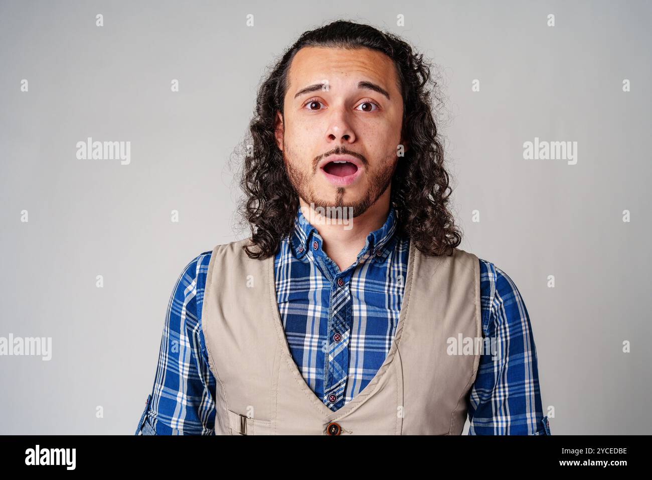 Surprised young man curly hair hi-res stock photography and images - Alamy