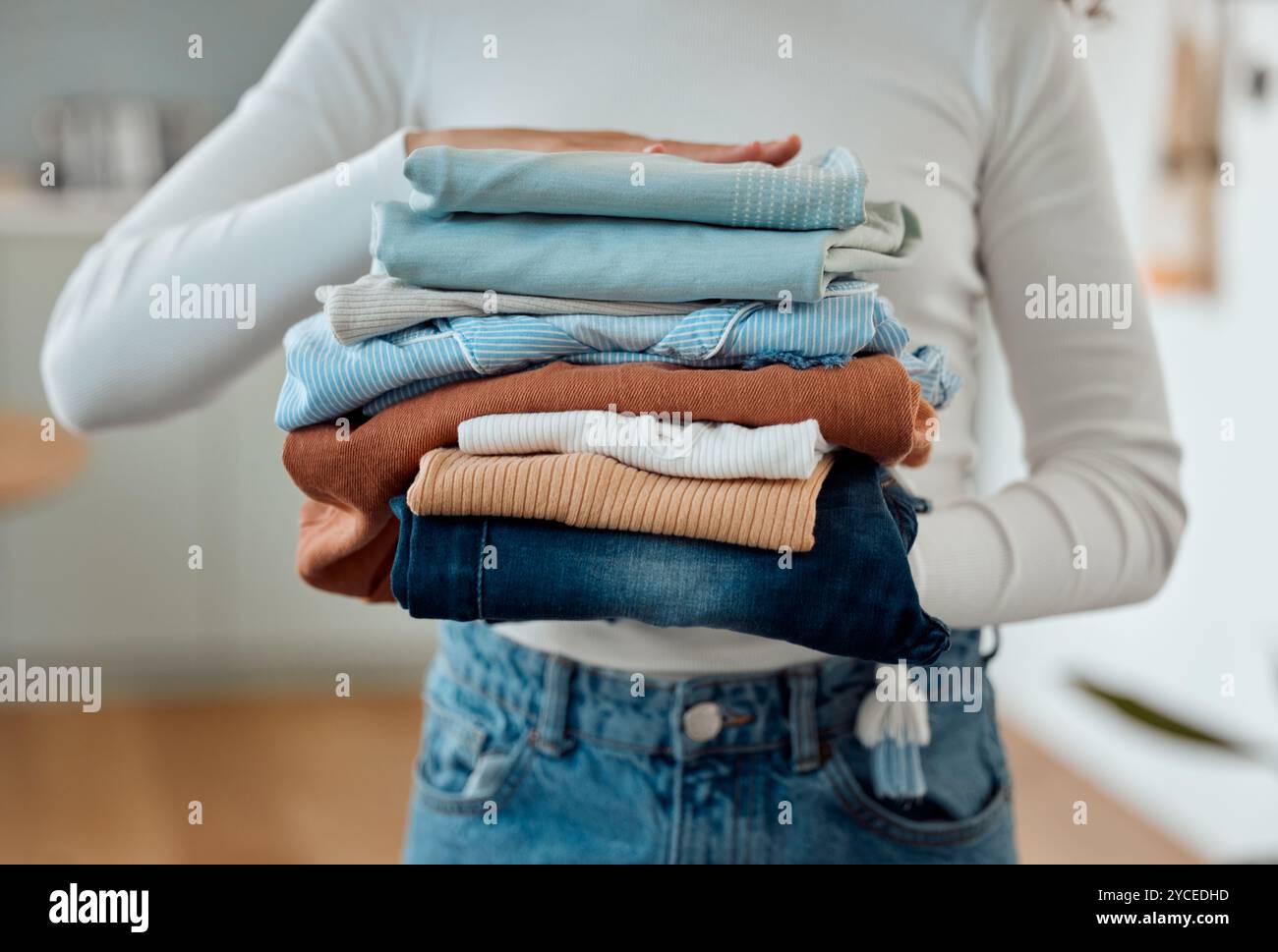 Laundry, hands and woman in home with clothes, housework and weekend ...