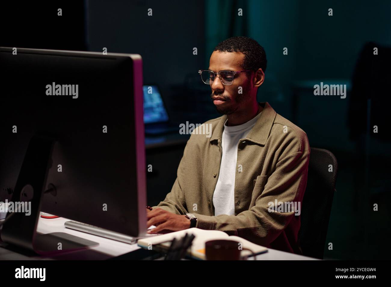 Working Late in Front of Computer Screen Stock Photo