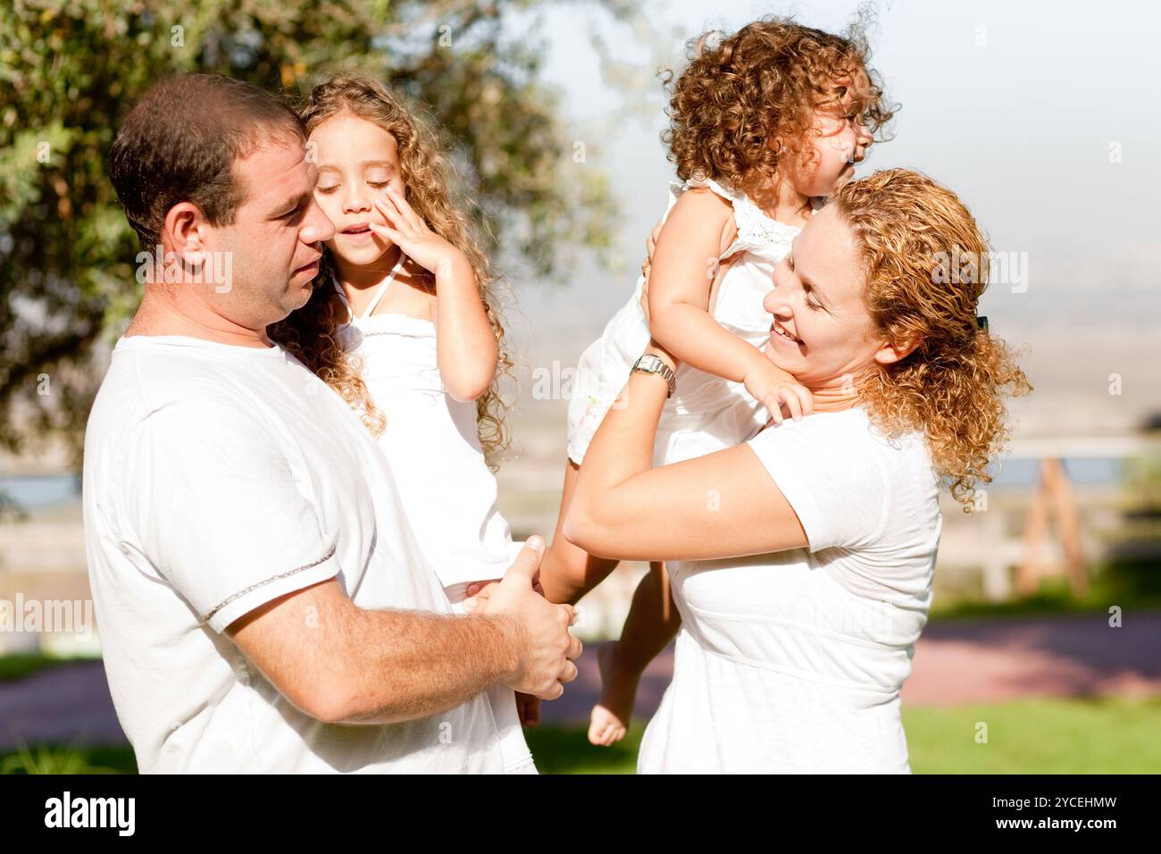 Parents with two kids side view Stock Photo - Alamy