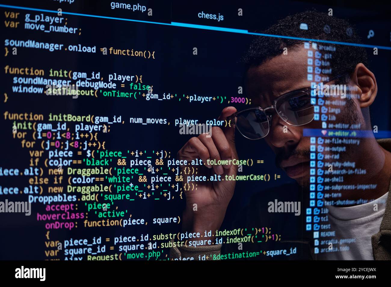 Focused Programmer Analyzing Code on Computer Screen Stock Photo