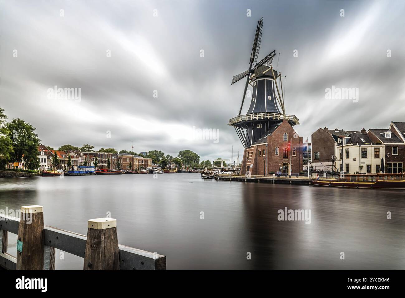 Haarlem, Netherlands, August 3, 2016: Picturesque and beautiful long exposure landscape with the windmill, the river and traditional houses in Haarlem Stock Photo