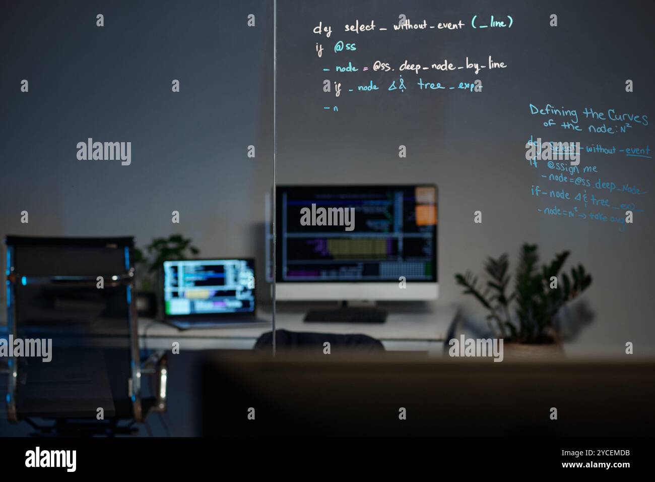Modern Office with Computer and Code on Glass Board Stock Photo - Alamy
