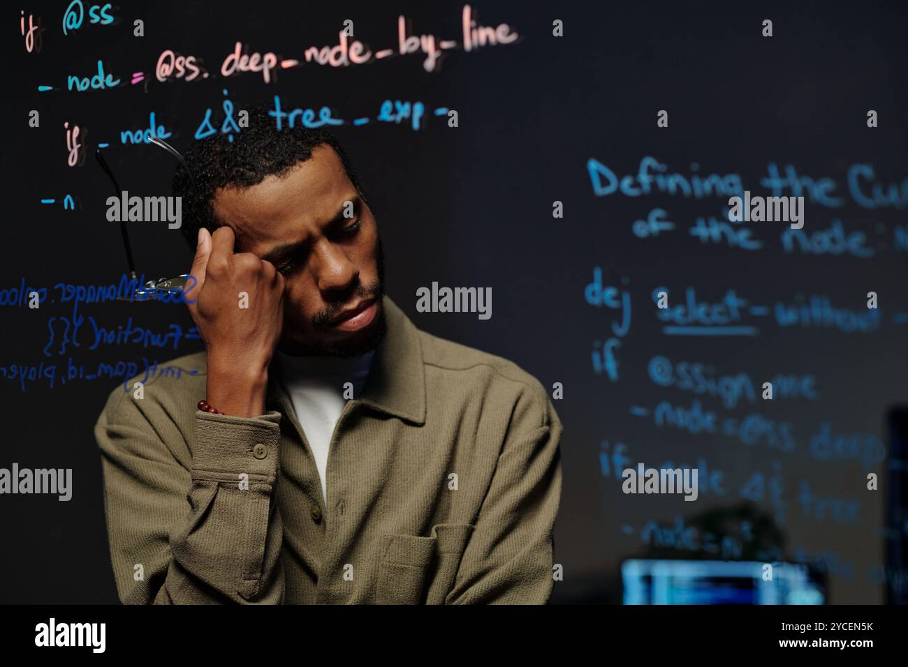 Pensive Developer Reading Code on Transparent Screen Stock Photo
