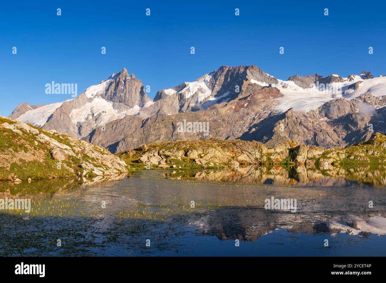 Lerie Lake in the Oisans Massif with scenic view of La Meije peak in Ecrins National Park at sunset. Emparis Plateau, Hautes-Alpes, Alps, France Stock Photo