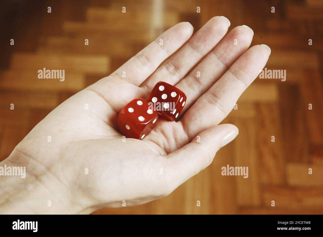 Female Hands holding two red Dice Stock Photo
