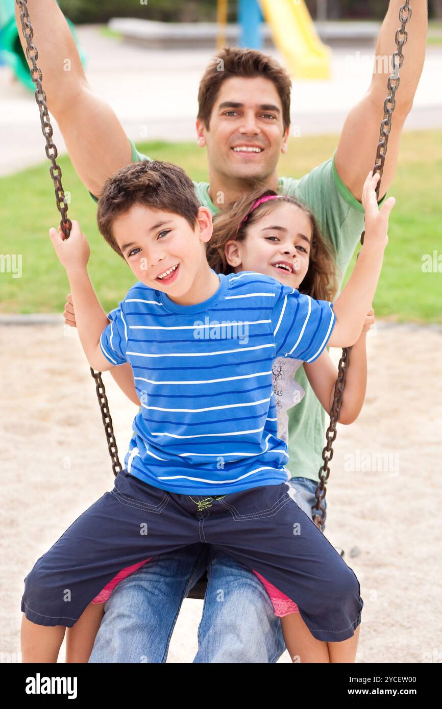 Father enjoying swing ride with his son in the park, outdoors Stock ...