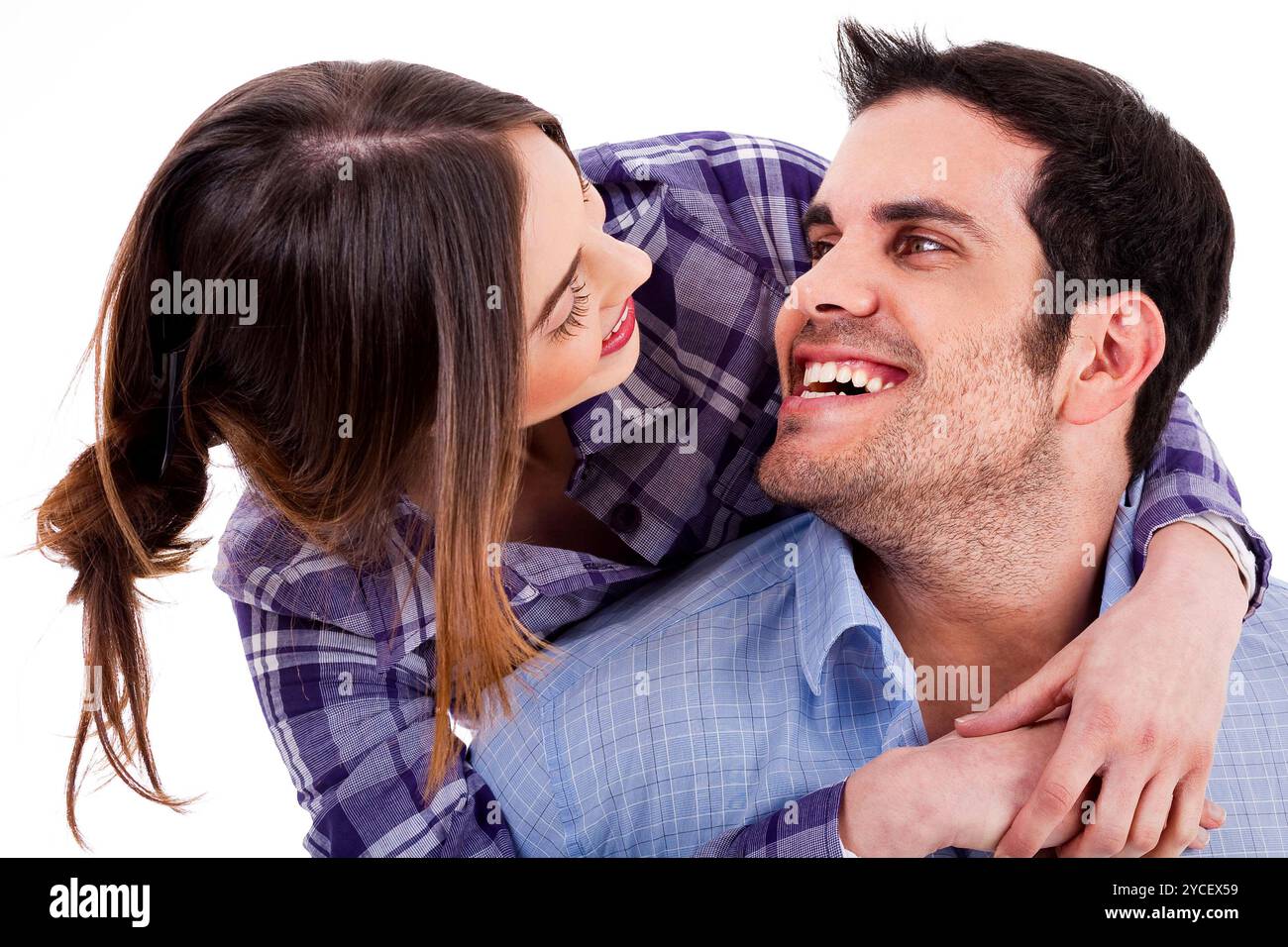 Closeup portrait of a cute young woman hugging her husband from behind ...