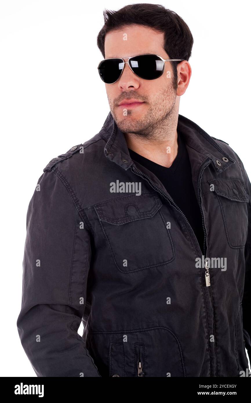 Portrait of stylish young man wearing sunglasses on an isolated background Stock Photo