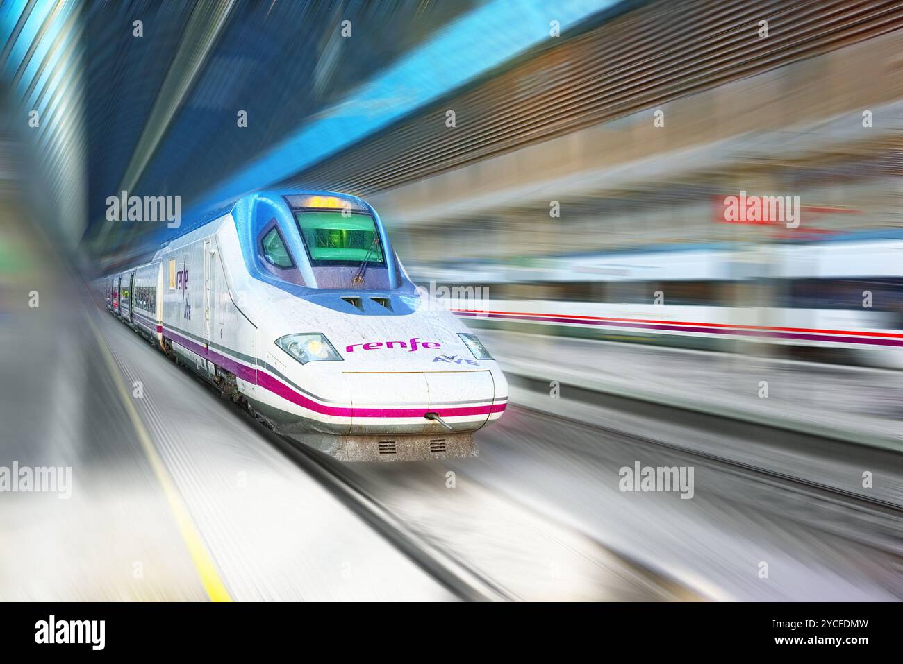 Madrid, Spain - June 08, 2017 : Modern hi-speed passenger train of Spanish Railways Company - Renfe, in  movement (motion). Stock Photo