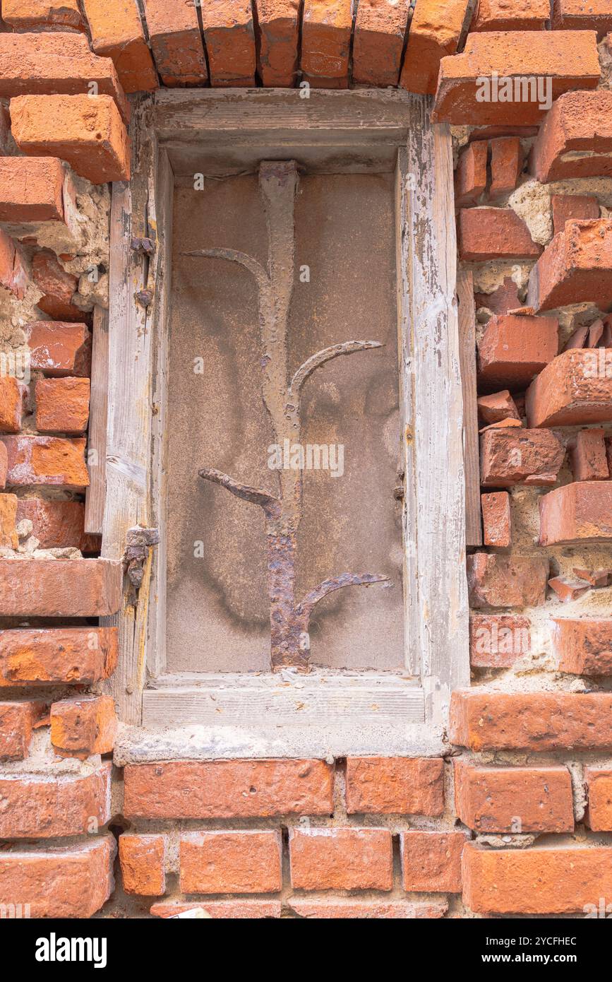 Barred window on a dilapidated house Stock Photo