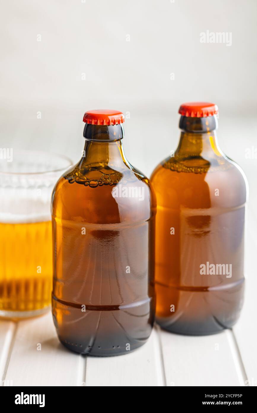 Two beer bottles on a white table. Stock Photo