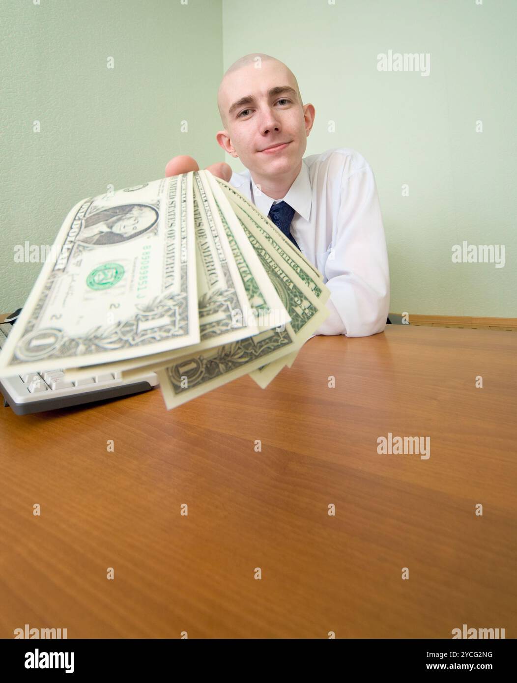 Chief stretching to us a pack of dollars Stock Photo