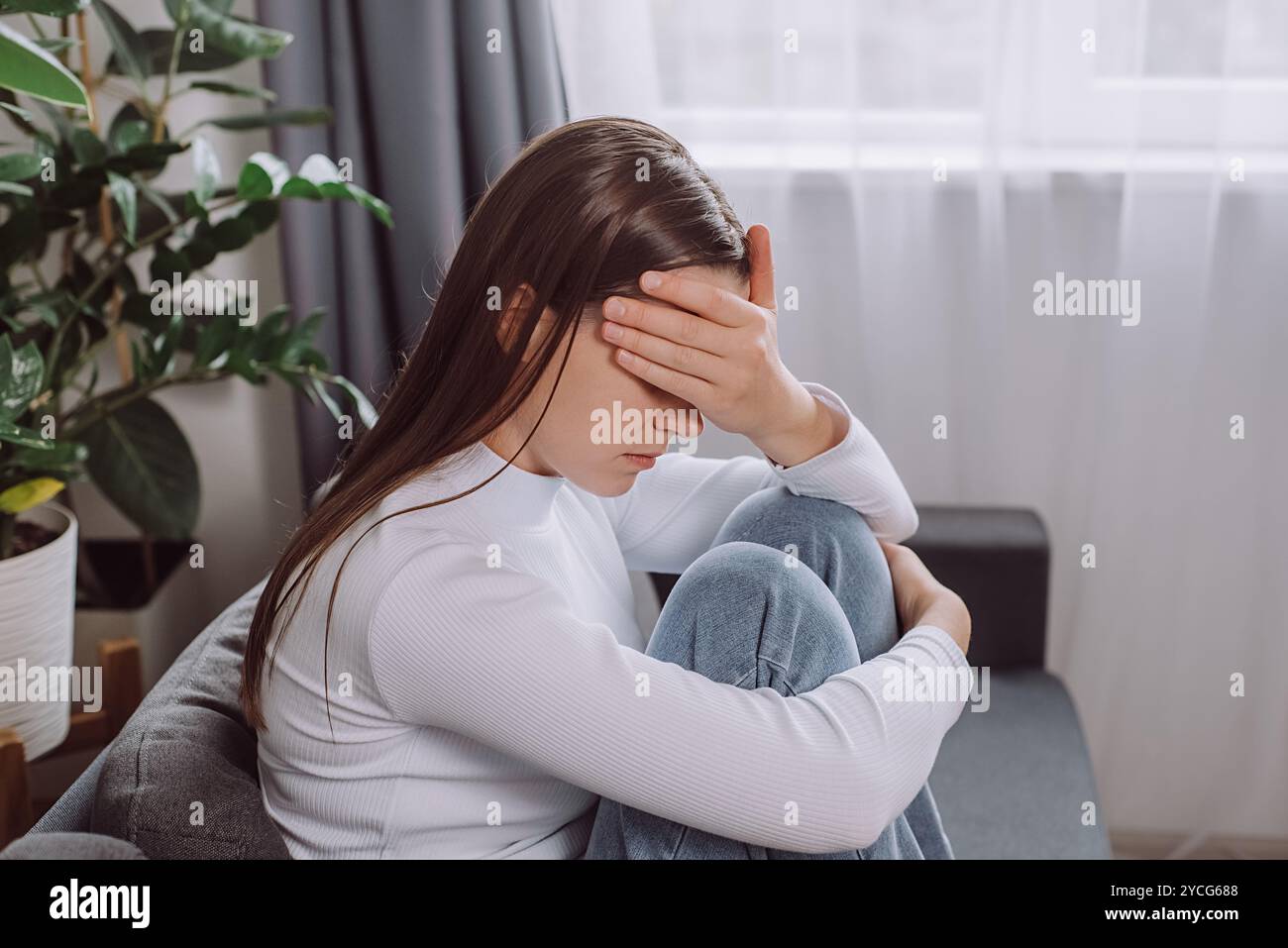 Depressed unhappy young brunette woman expression face thinking about problem sitting on couch, difficulty, feeling failure and exhausted, suffering f Stock Photo