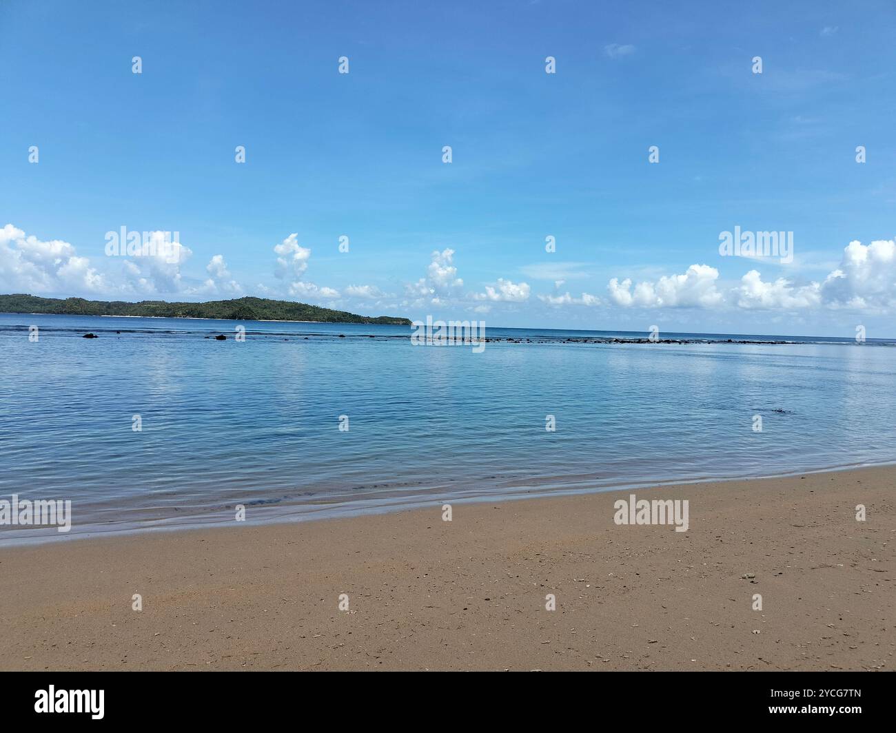 Beautiful beach under a bright, clear sky, showcasing serene coastal views with soft sand and turquoise waters - Smartphone Captured Stock Image