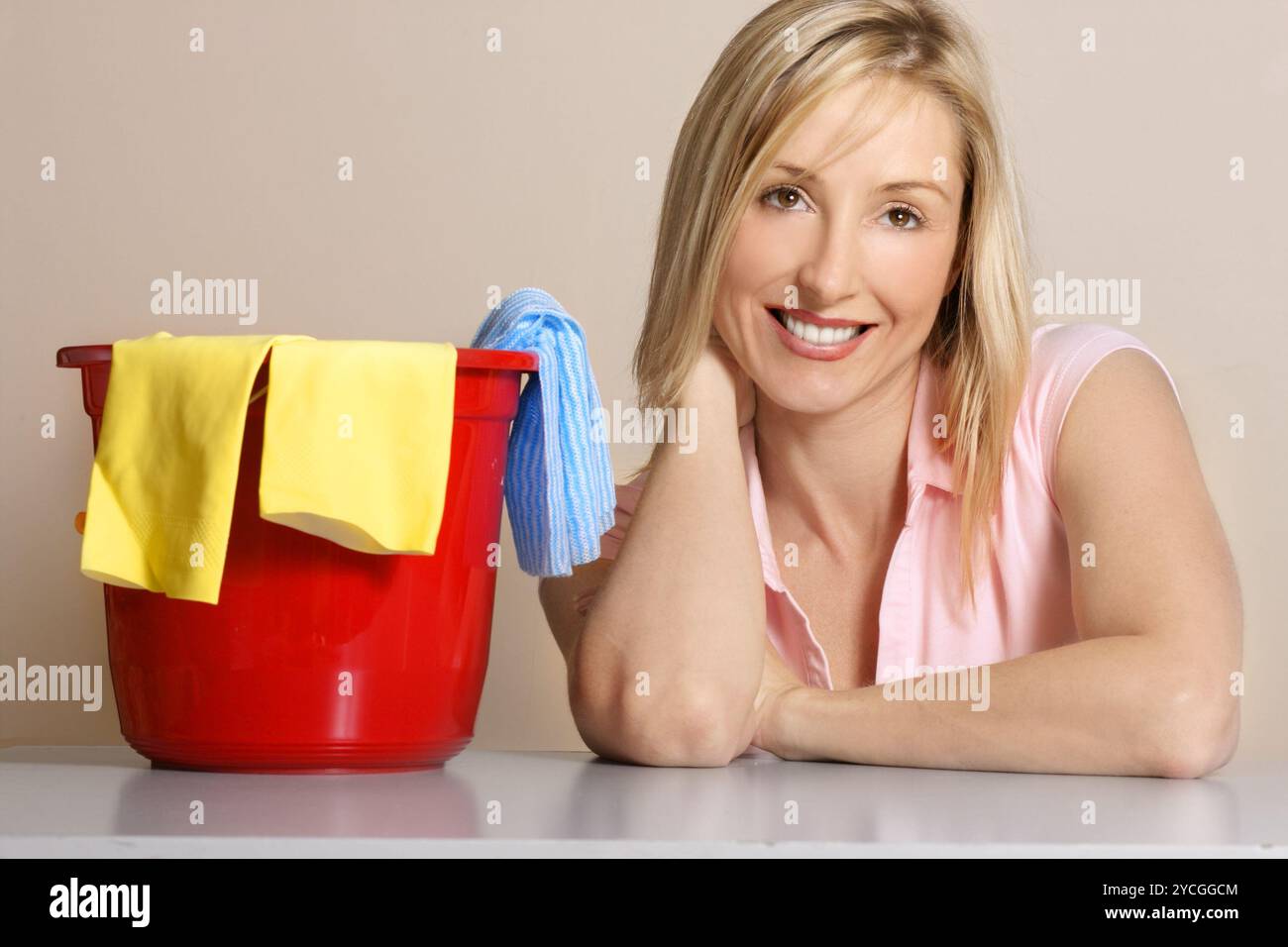 This image depicts a woman with a cleaning bucket, gloves and cleaning ...