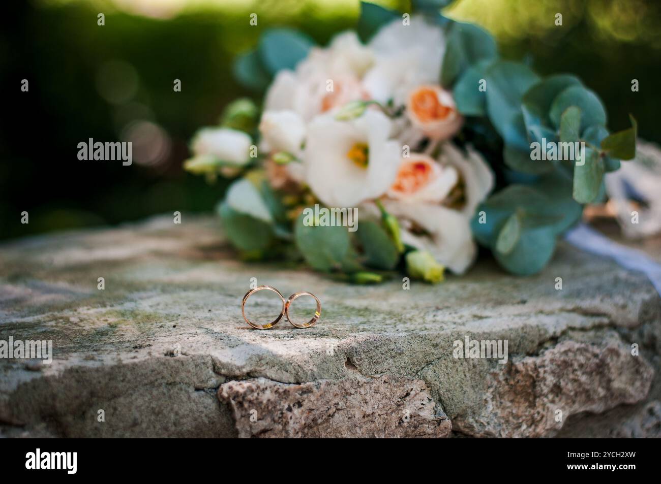 romantic-wedding-moment-with-floral-bouquets-and-wedding-rings-2YCH2XW.jpg