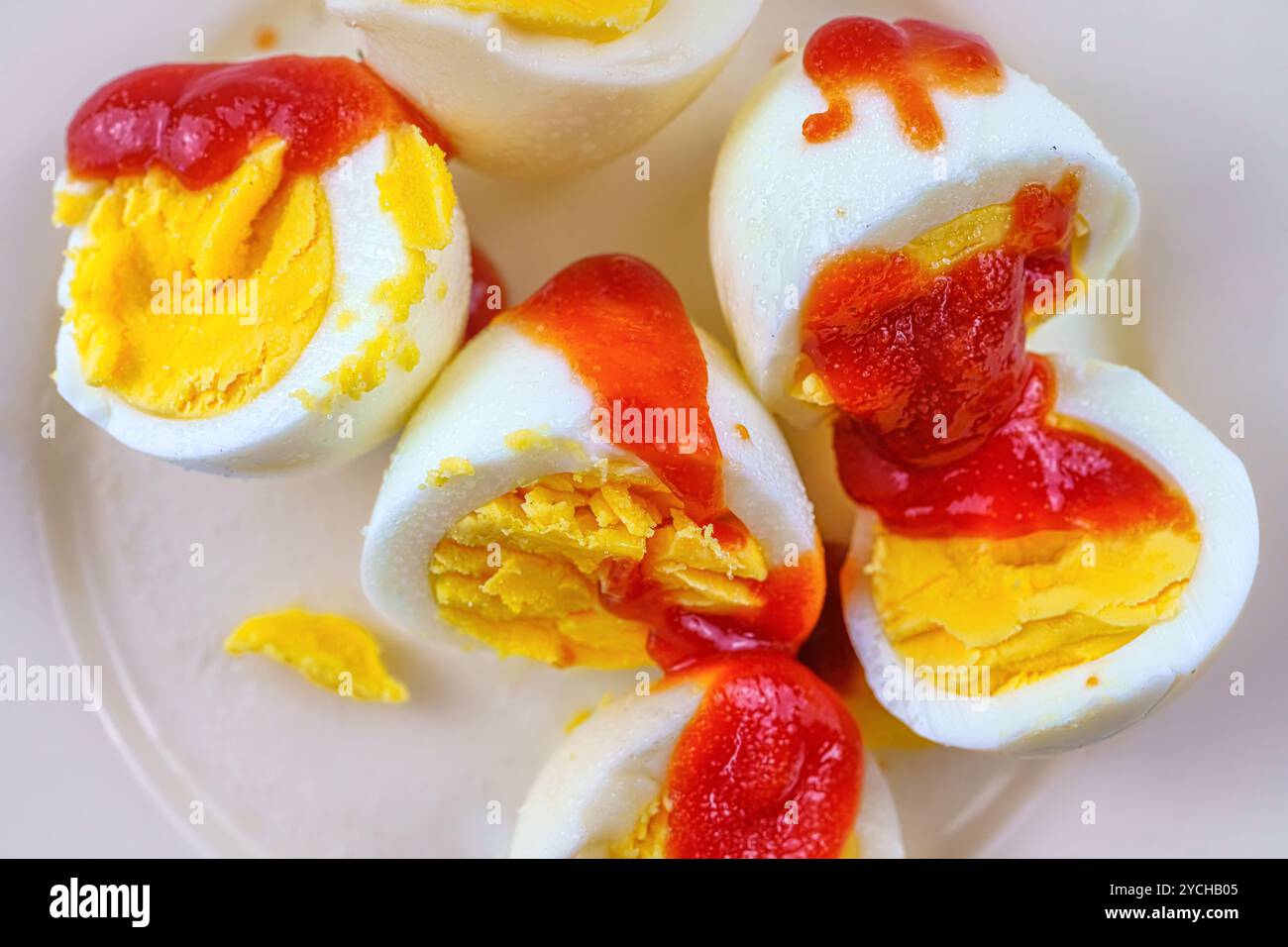 Boiled eggs with ketchup and salt. Stock Photo