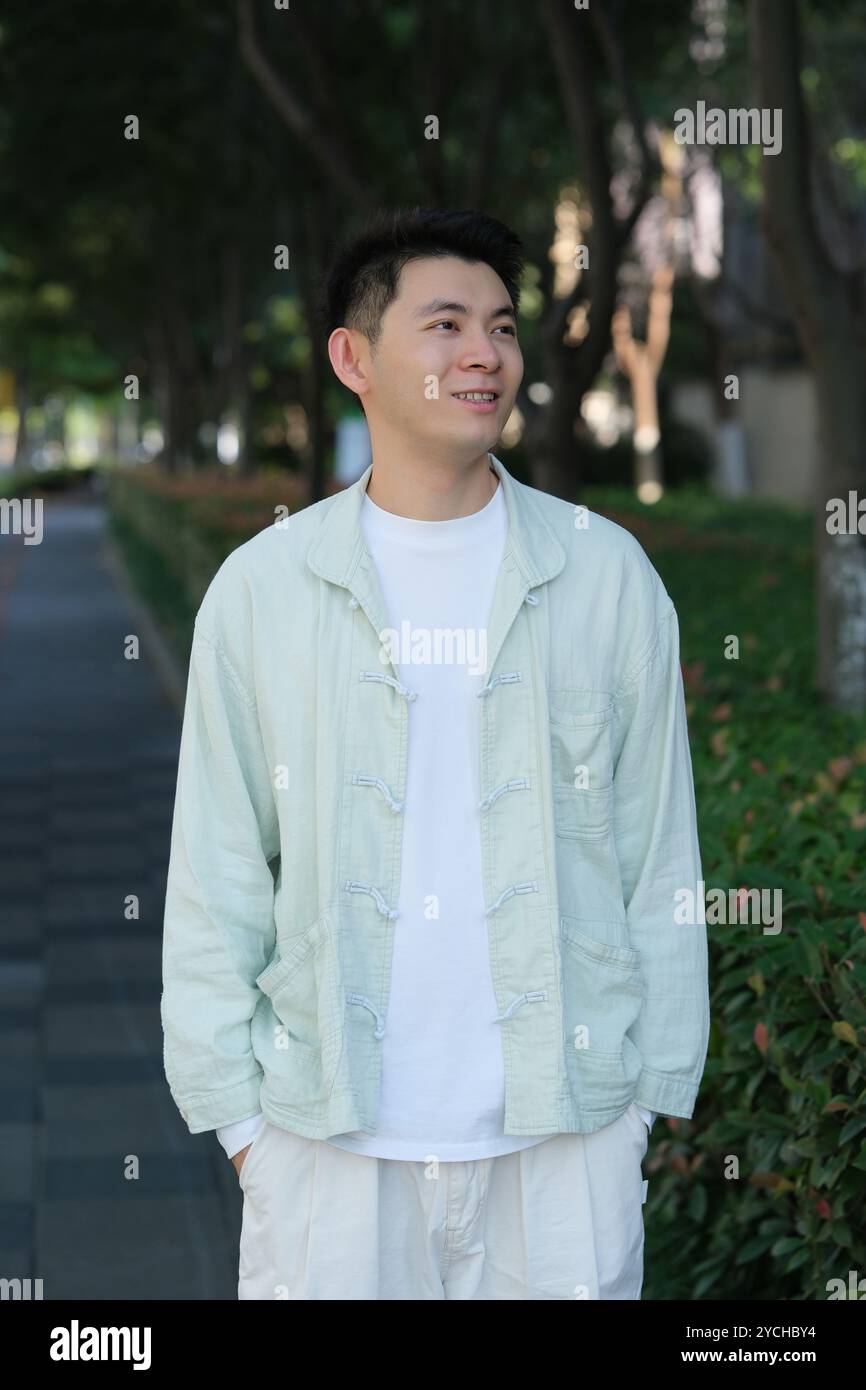 smiling Chinese young man outdoor Stock Photo