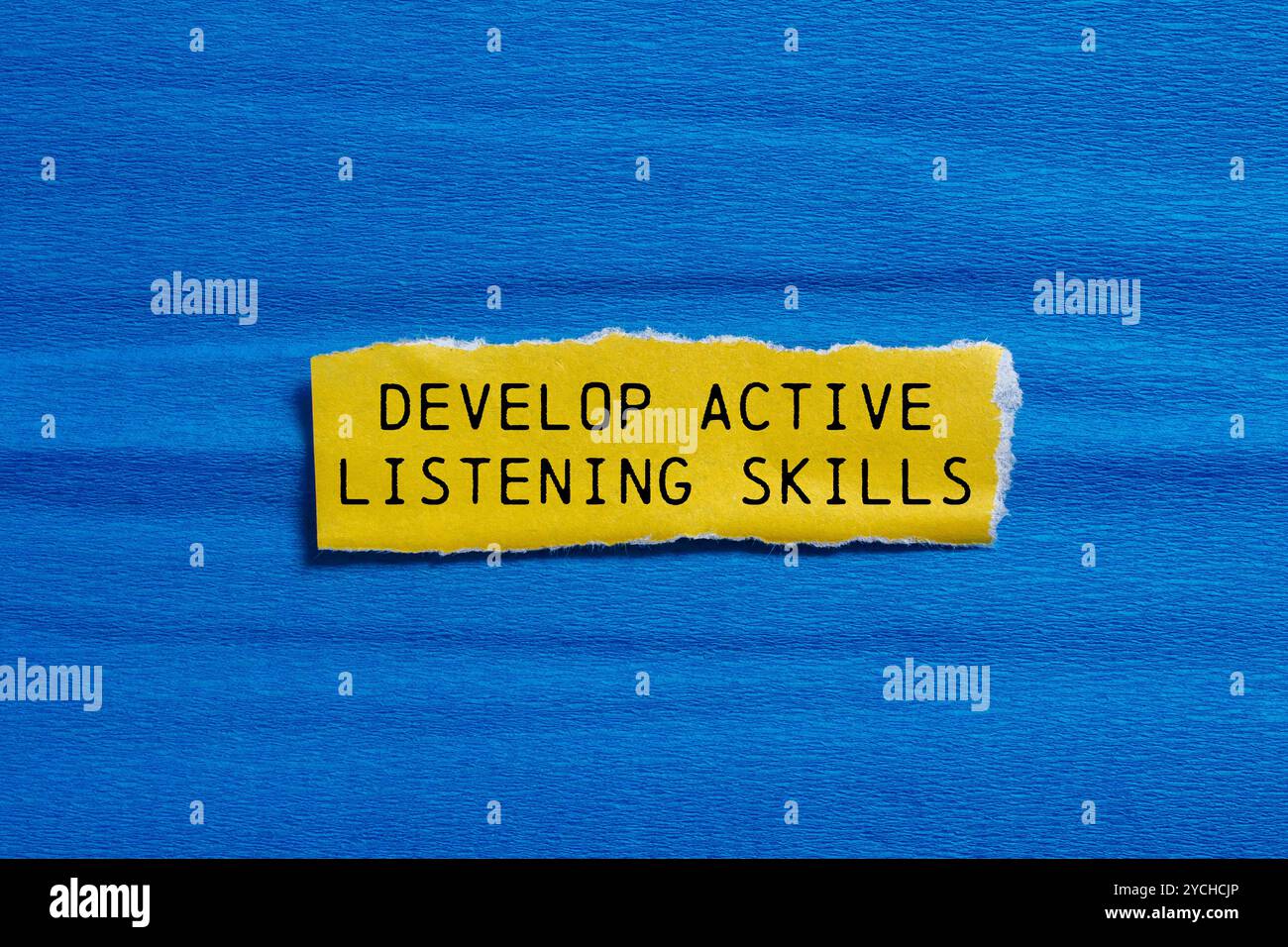 Develop active listening skills message written on ripped yellow torn ...