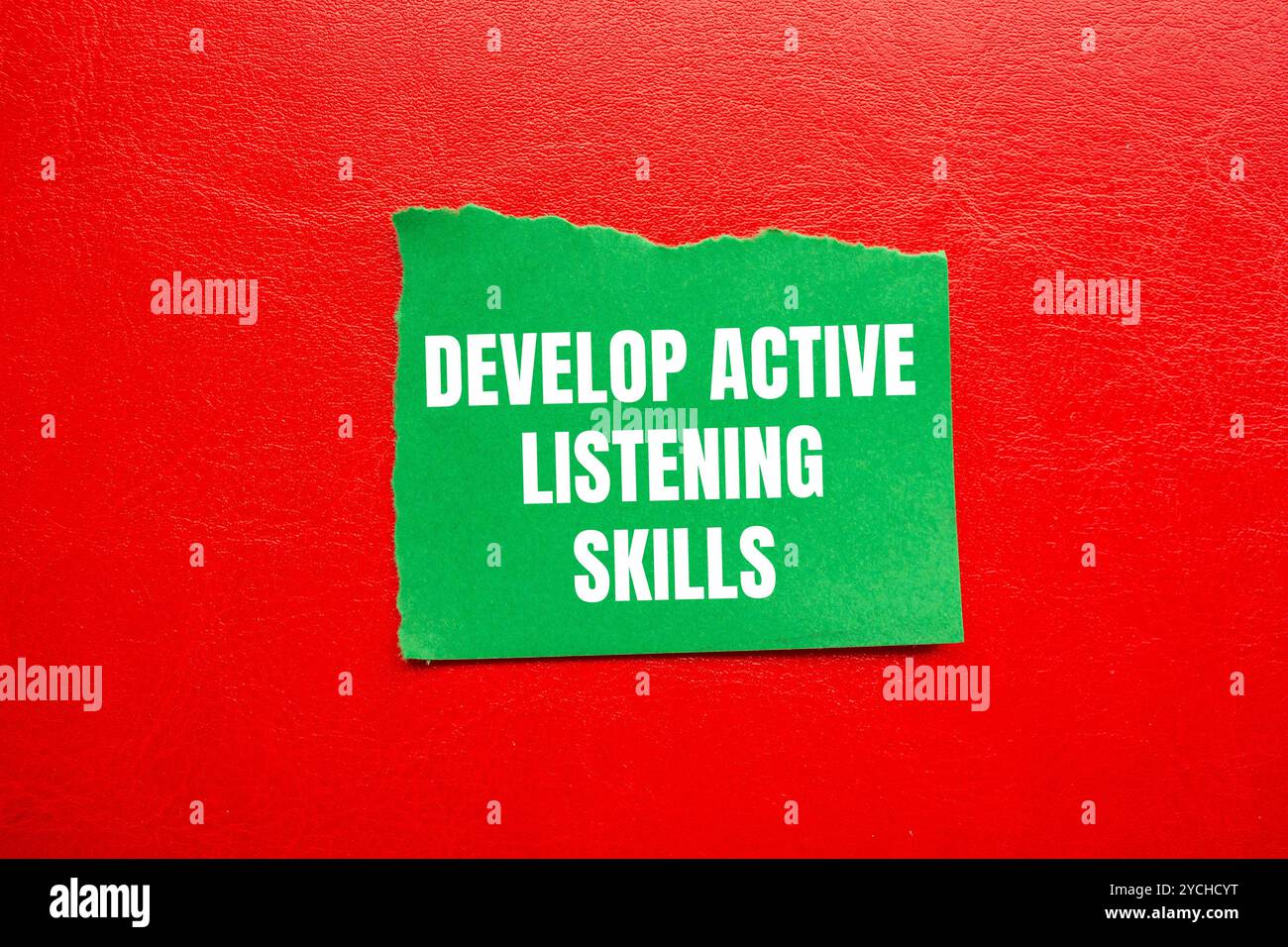 Develop active listening skills message written on ripped torn green ...