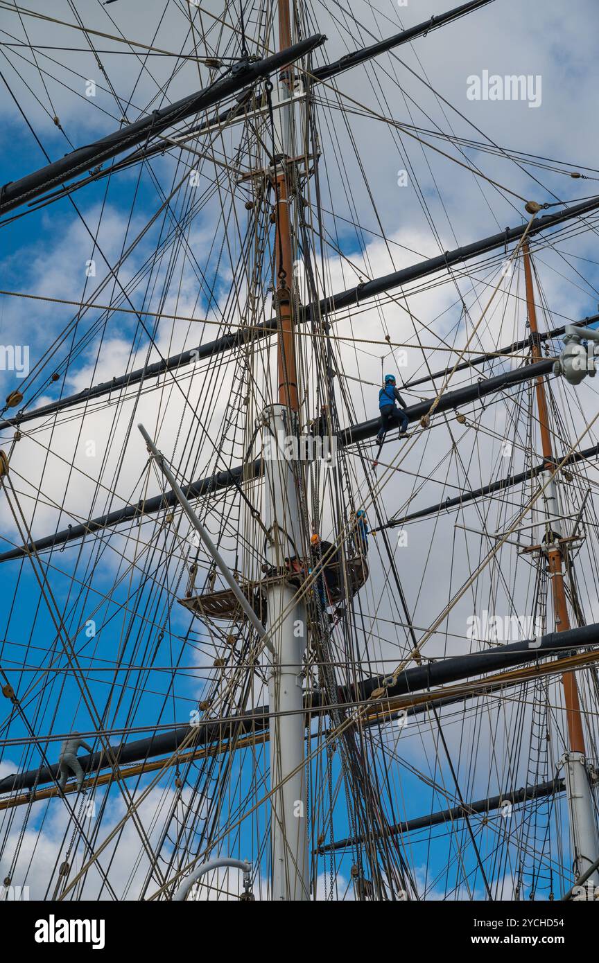 Climbers scaling the mast rigging on the Cutty Sark tea clipper museum ...