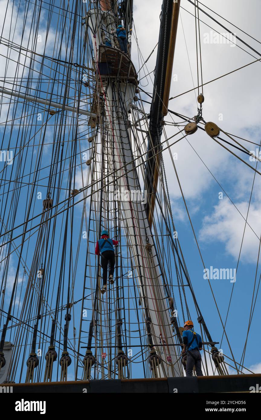Climbers scaling the mast rigging on the Cutty Sark tea clipper museum ...