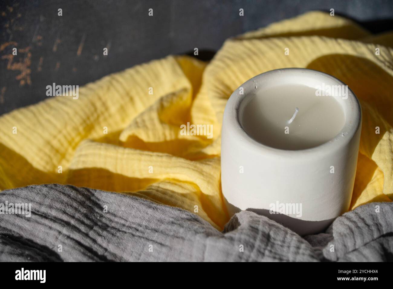 Homemade white ceramic candles on grey background. Stock Photo