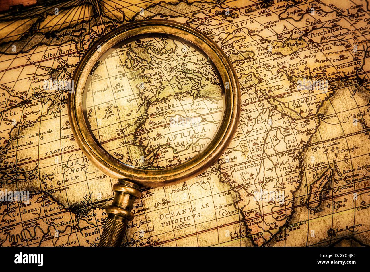 Vintage magnifying glass lies on an ancient world map Stock Photo - Alamy