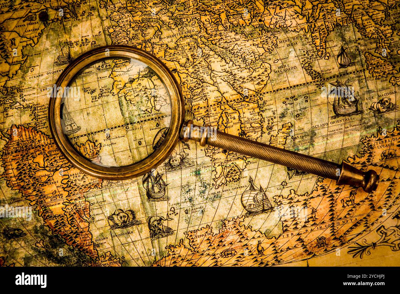 Vintage magnifying glass lies on an ancient world map Stock Photo - Alamy