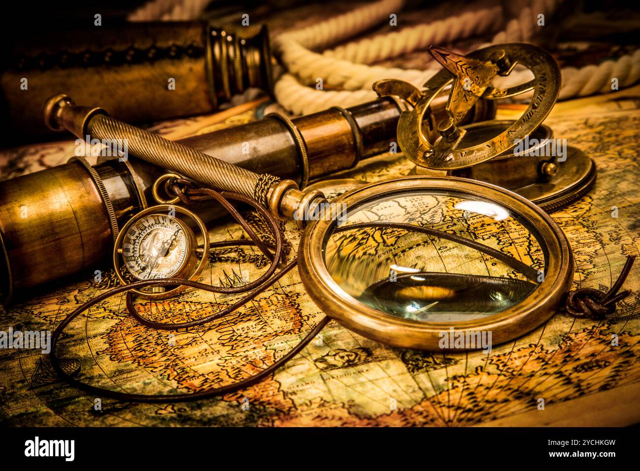 Vintage magnifying glass lies on an ancient world map Stock Photo - Alamy