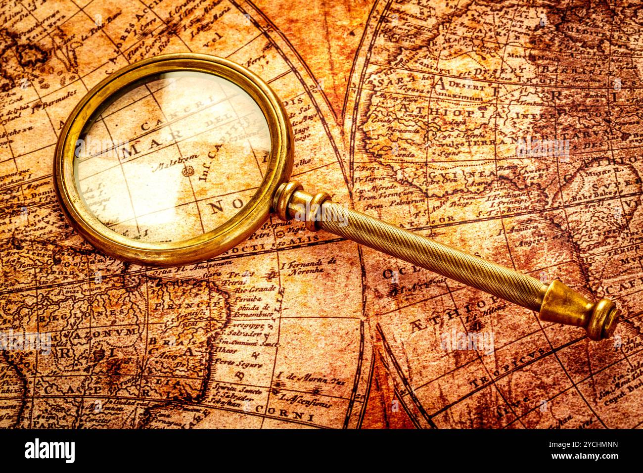 Vintage magnifying glass lies on an ancient world map Stock Photo - Alamy