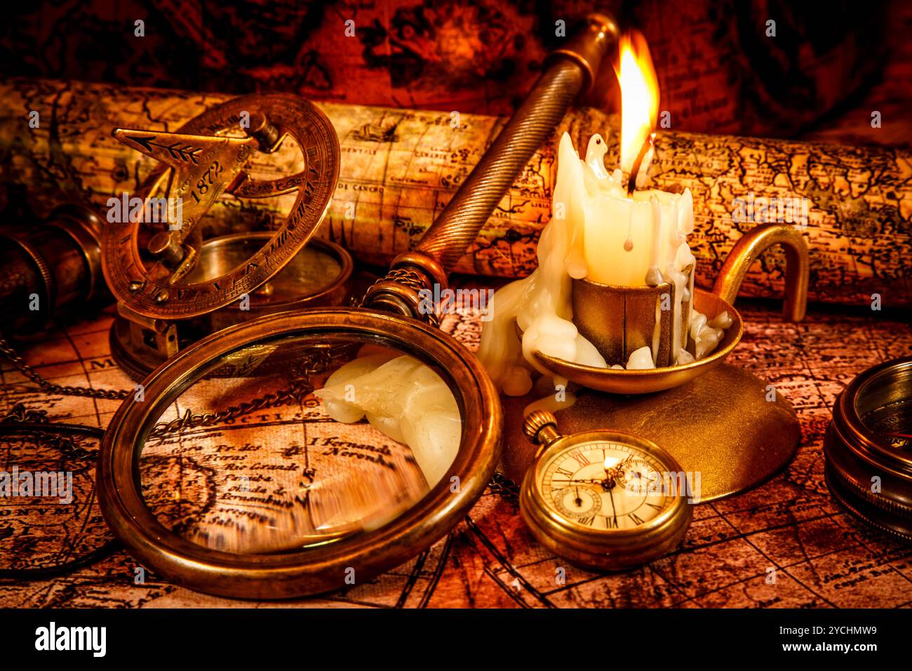 Vintage compass, magnifying glass, spyglass lie on an old ancient map ...