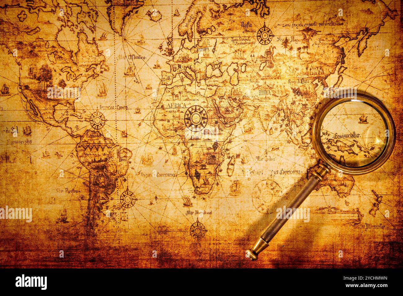 Vintage magnifying glass lies on an ancient world map Stock Photo - Alamy