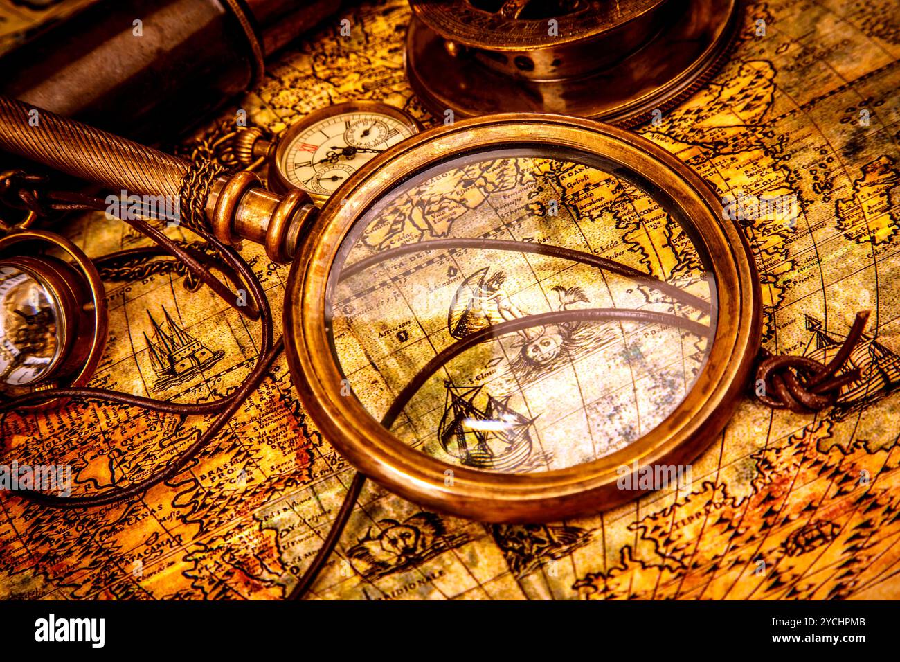 Vintage magnifying glass lies on an ancient world map Stock Photo - Alamy