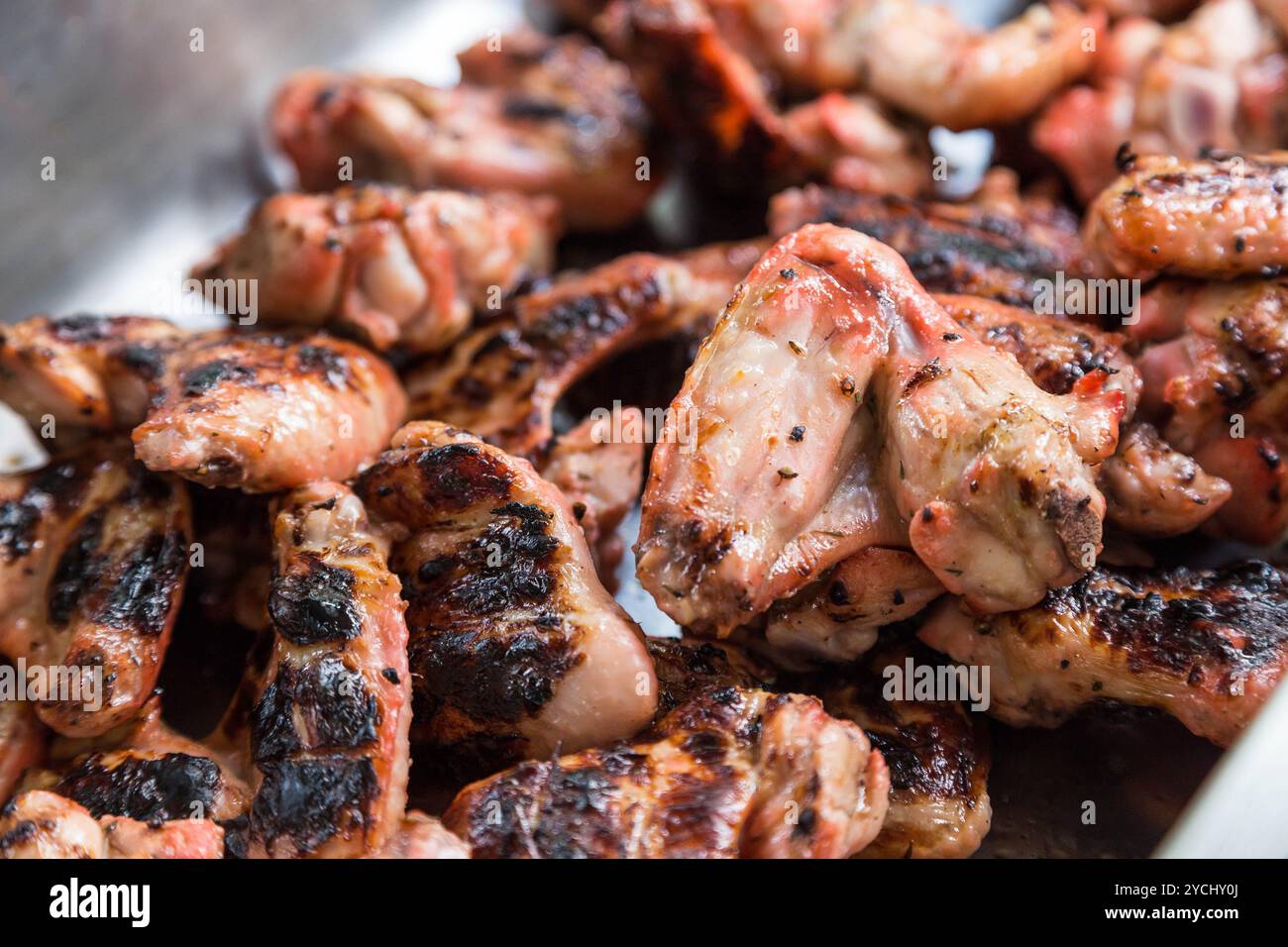 Juice marinated chicken wings on barbecue Stock Photo