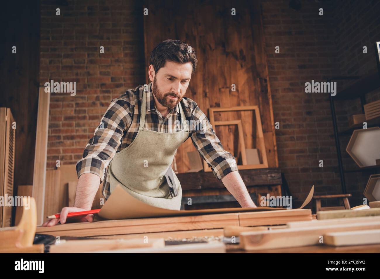 Photo of professional artisan guy builder look learn blueprint project ...