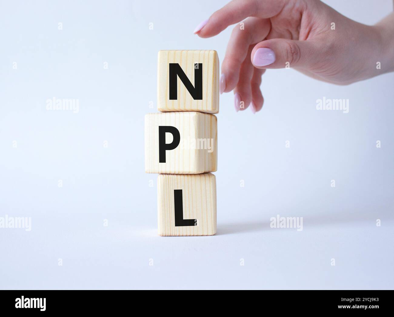 NPL - Non Performing Loan symbol. Concept word IPO on wooden cubes. Businessman hand. Beautiful white background. Business and NPL concept. Copy space Stock Photo