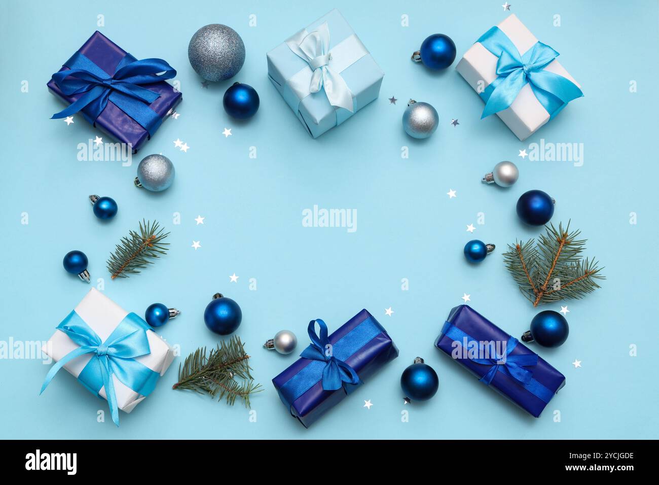Frame made from gift boxes, fir branches and Christmas baubles on blue ...