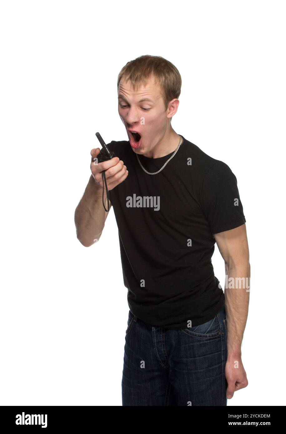 Young security officer talking through his walkie talkie. Stock Photo