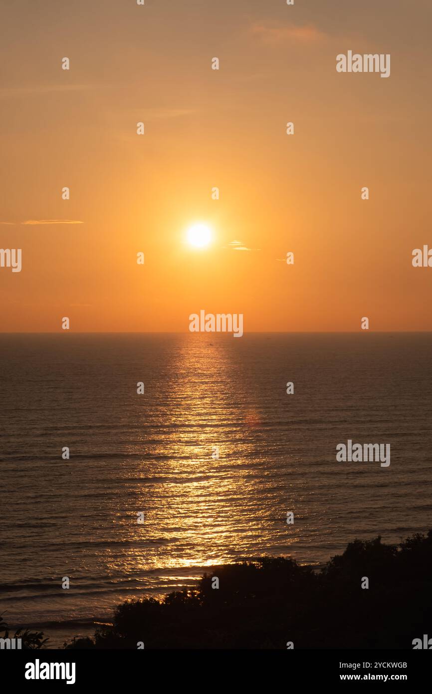 Colorful sunset over ocean in Goa India. Dramatic sunset over the sea. Beautiful red and orange sunrise over the sea. Beautiful seascape scenery, Amaz Stock Photo