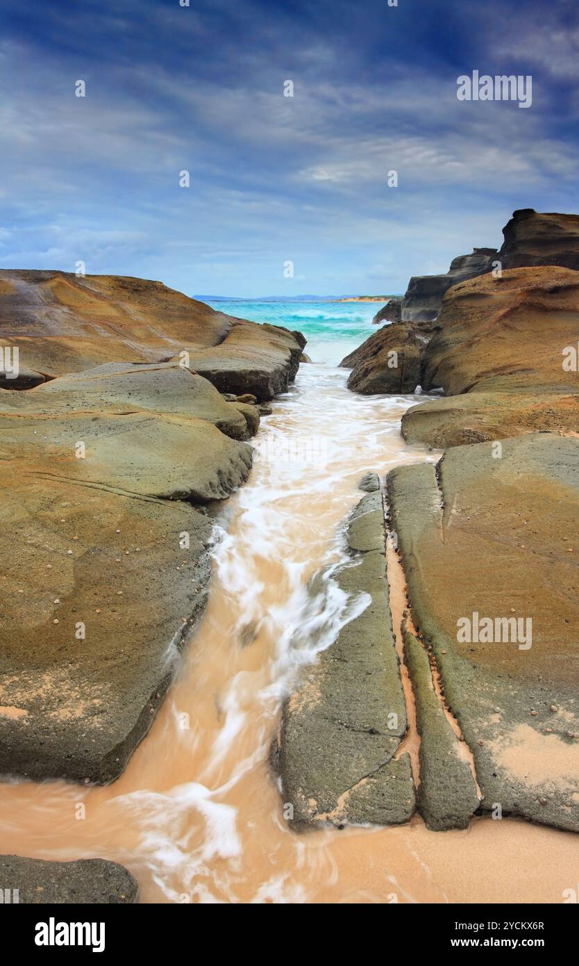 Steadfast,  Sea wash through rock crevice Stock Photo