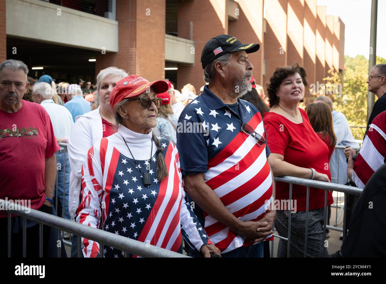 Duluth, Georgia, USA. 23rd Oct, 2024. An elderly couple dressed in patriotic outfits waits in queue for hours before massive rally in final weeks of 2024 presidential campaign. (Credit Image: © Robin Rayne/ZUMA Press Wire) EDITORIAL USAGE ONLY! Not for Commercial USAGE! Stock Photo