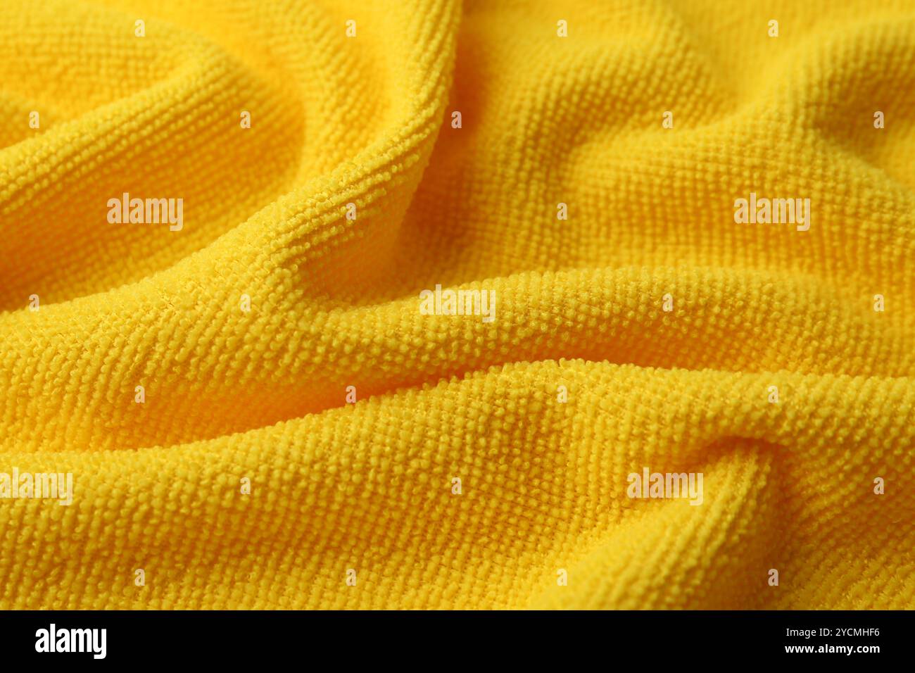 Clean yellow microfiber cloth as background, closeup Stock Photo