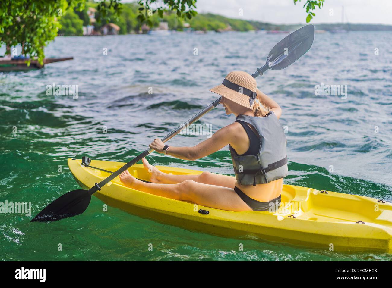 Woman kayaking on Bacalar Lake in Mexico. Adventure tourism in Quintana ...