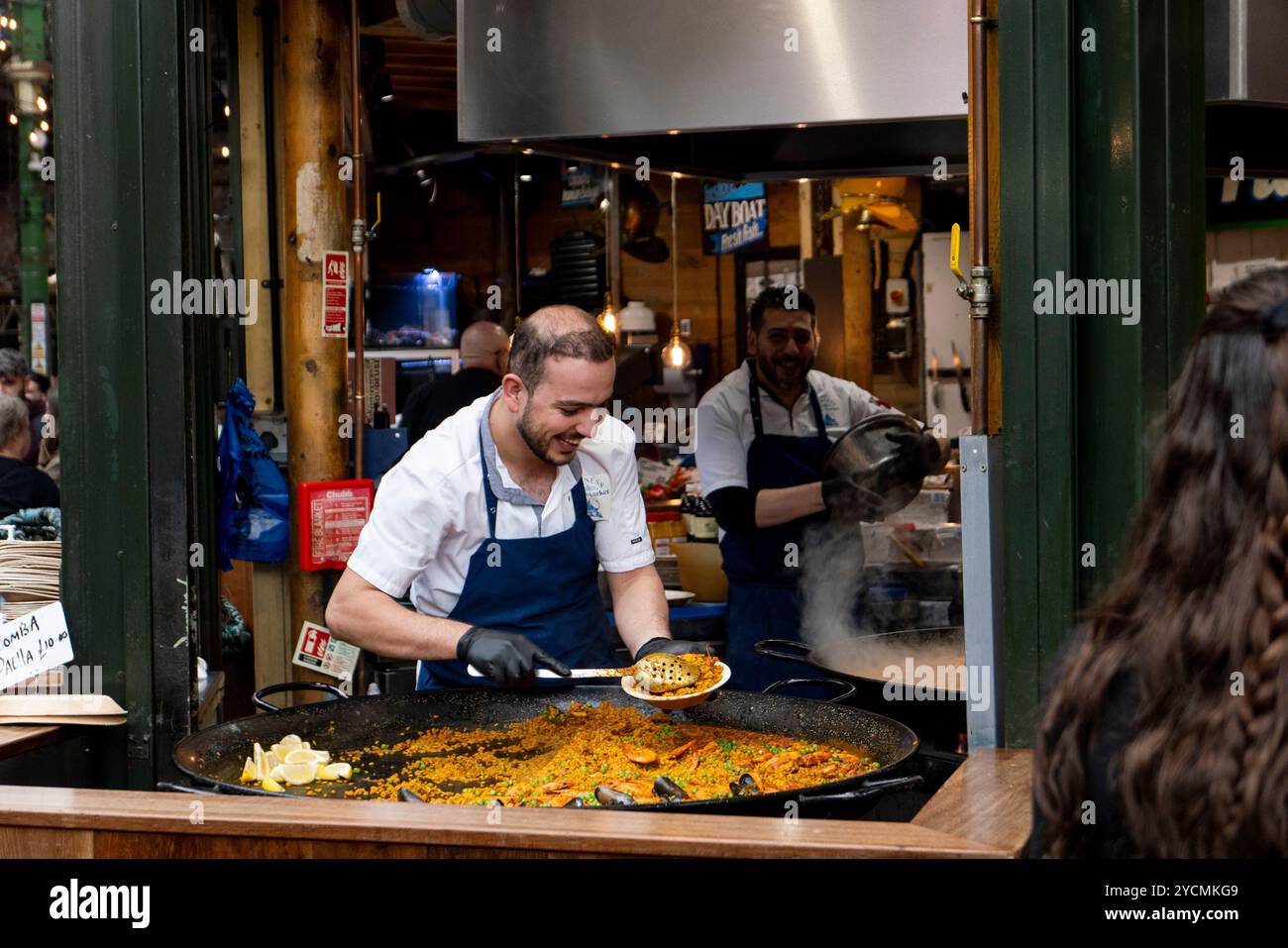 Male chef serving paella hi-res stock photography and images - Alamy