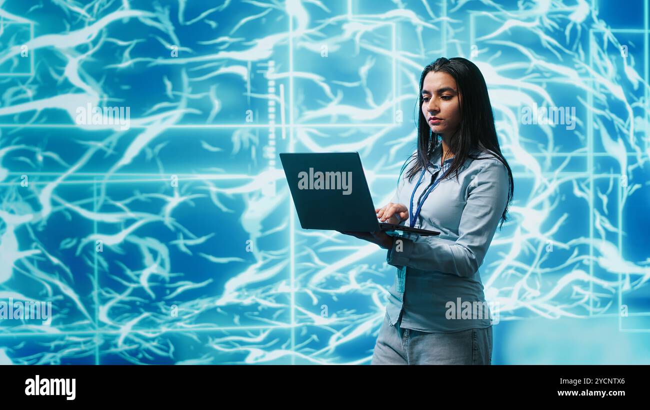 Software developer solving tasks on laptop, running artificial intelligence programming scripts. Woman using notebook to write lines of code for AI applications development, camera A Stock Photo